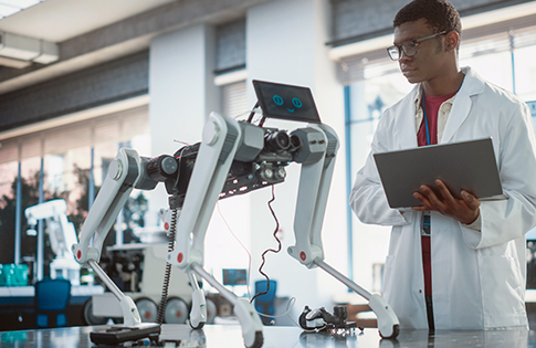 Engineer Testing Industrial Programmable Robot Animal in a Factory Development Workshop