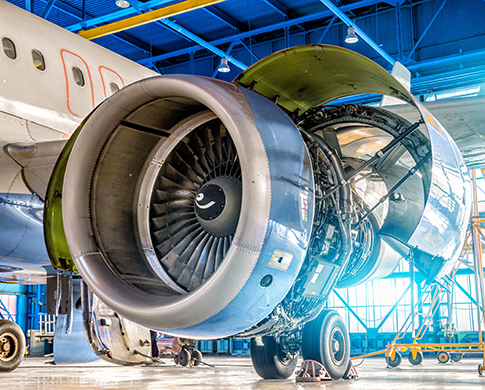 Airplane engine jet on the wing during repair in the hangar