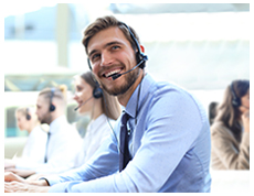 smiling man with headset on answering call